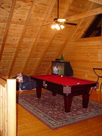 The loft gameroom  had a pool table, a big screen HDTV, and an arcade game machine!